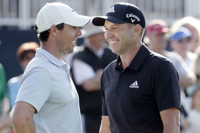 Sergio Garcia, right, talks to Rory McIlroy during the first round of the Players Championship. Picture: Lynne Sladky/AP