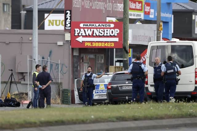 Police stand outside a mosque in Linwood, Christchurch, New Zealand. (AP Photo/Mark Baker)