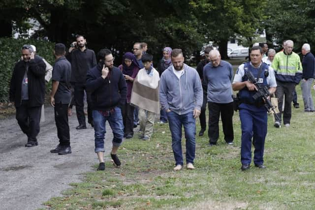 Police escort witnesses away from a mosque in central Christchurch. (AP Photo/Mark Baker)