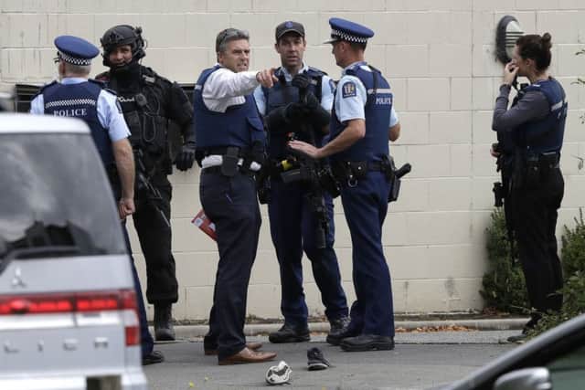 Police stand outside a mosque in central Christchurch, New Zealand. (AP Photo/Mark Baker)