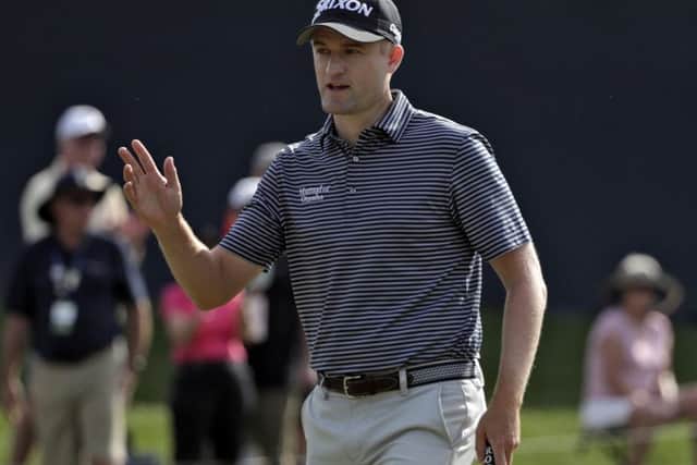 Russell Knox waves to the gallery after making a putt on the ninth at Sawgrass. Picture: Lynne Sladky/AP