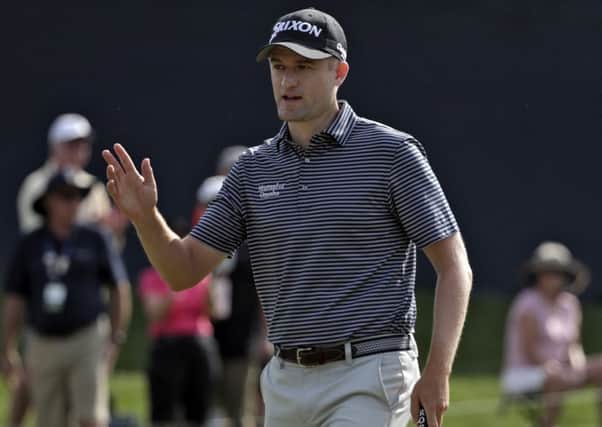 Russell Knox waves to the gallery after making a putt on the ninth at Sawgrass. Picture: Lynne Sladky/AP