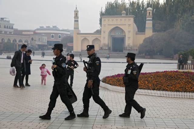 Uyghur security personnel patrol near the Id Kah Mosque in Kashgar in Chinas Xinjiang region (Picture: Ng Han Guan/AP)