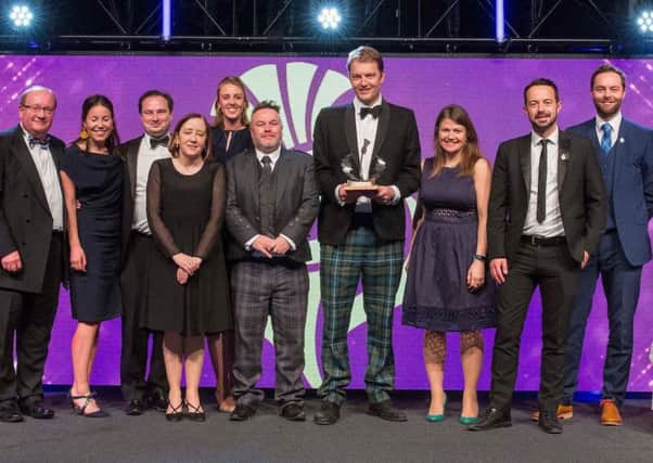 Rory Colville, tournament director of the Aberdeen Standard Invesments Scottish Open, receives the award along with other members of the team involved in the event
