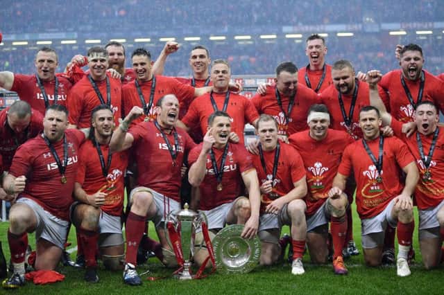 The Wales team celebrate with the trophy after winning the Six Nations and the Grand Slam by dominating Ireland. Picture: Dan Mullan/Getty Images