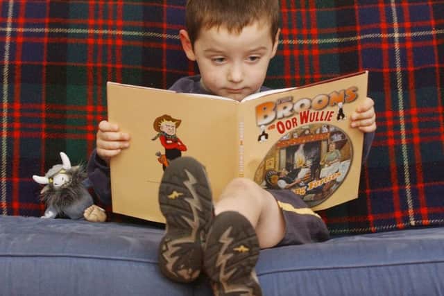 A child reading the Broons and Oor Wullie Annual
 Pic: Neil Hanna