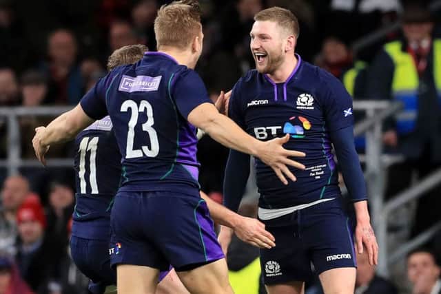 Man of  the match Finn Russell celebrates with replacement Chris Harris after scoring Scotlands equalising try. Picture: PA.