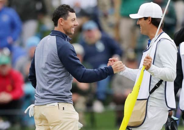 Rory McIlroy celebrates with his caddie Harry Diamond after holing the winning putt in the Players Championship at Sawgrass. Picture: Getty