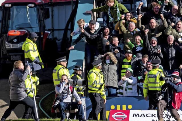 Neil Lennon (lower left) raced up the touchline to celebrate with the travelling fans. Picture: SNS Group