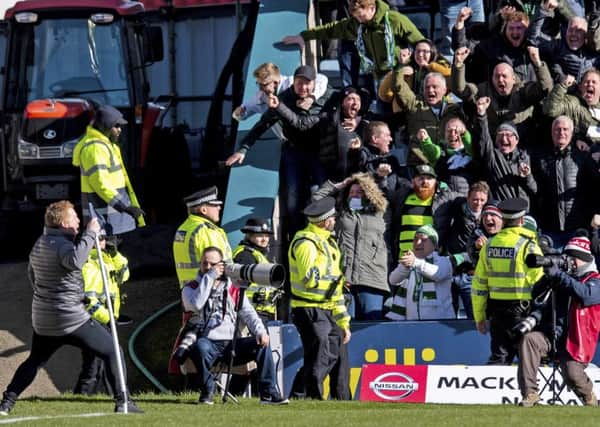 Neil Lennon (lower left) raced up the touchline to celebrate with the travelling fans. Picture: SNS Group