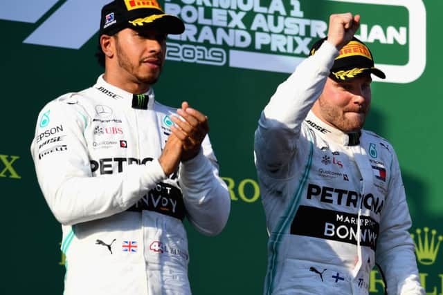 Lewis Hamilton applauds as Australian GP winner Valtteri Bottas salutes the Melbourne crowd. Picture: Getty.