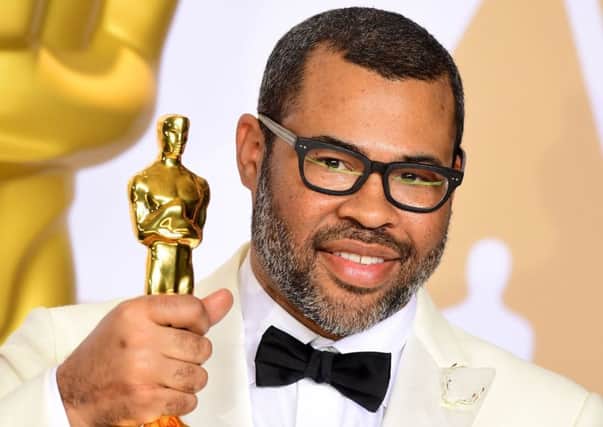 Jordan Peele with his Best Original Screenplay Oscar for Get Out. Picture: Ian West/PA Photos