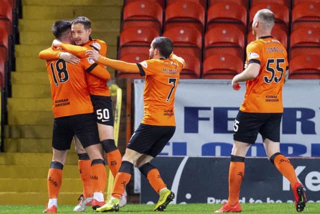 Calum Butcher, left, celebrates with team-mates after putting Dundee United ahead in the seventh minute. Picture: SNS