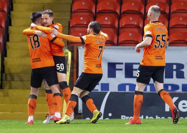 Calum Butcher, left, celebrates with team-mates after putting Dundee United ahead in the seventh minute. Picture: SNS