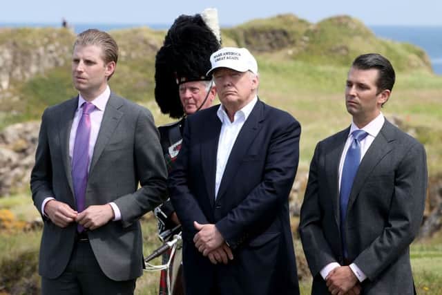 Donald Trump Jr (right) with his father at the Turnberry golf course in 2016. Picture: PA