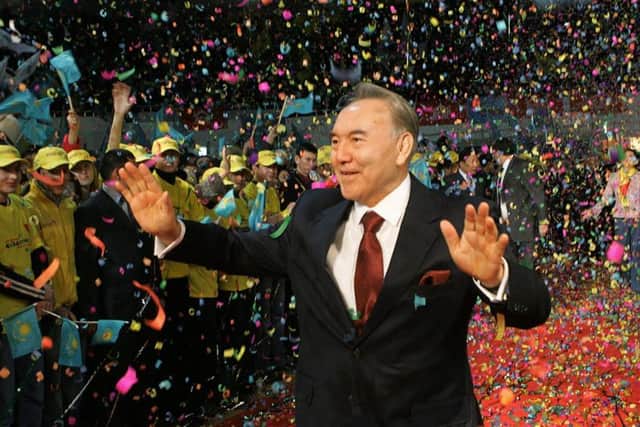 Outgoing Kazakhstan President Nursultan Nazarbayev waves to supporters after his victory in the 2005 election. Picture: AP