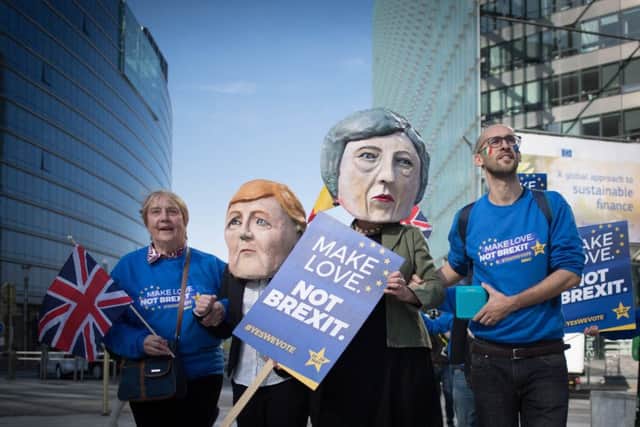Anti-Brexit protesters dressed as Theresa May and Angela Merkel outside the EU Commission in Brussels today. Picture: PA