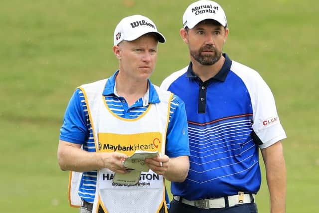 Padraig Harrington talks tactics with caddie Ronan Flood during the first round of the Maybank Championship in Malaysia. Picture: Getty Images