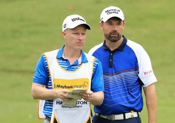 Padraig Harrington talks tactics with caddie Ronan Flood during the first round of the Maybank Championship in Malaysia. Picture: Getty Images