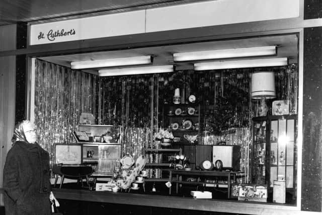 A woman checks out the Christmas window display at St Cuthberts Co-Operative Association on Nicolson Street.