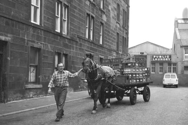 Mr Anderson with Jackie the milk horse from the St Cuthbert's Co-operative horses' stables in Grove Street Fountainbridge in November 1975.