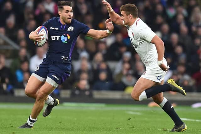 Scotland winger Sean Maitland hands off England's Henry Slade. Picture: Glyn Kirk/AFP/Getty Images