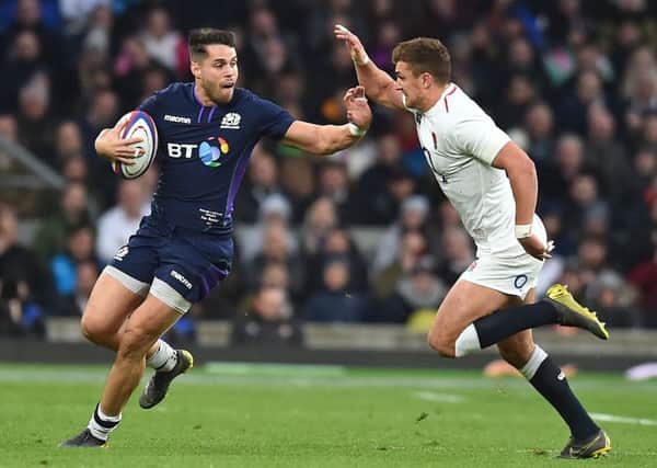 Scotland winger Sean Maitland hands off England's Henry Slade. Picture: Glyn Kirk/AFP/Getty Images