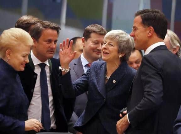 Prime Minister Theresa May greets fellow EU leaders in Brussels