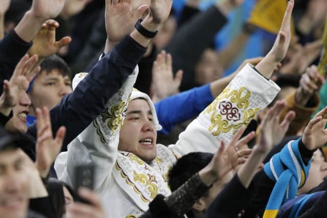 Kazakhstan fans cheer their team to Thursday's historic win over Scotland. Picture: Alexei Filippov/AP