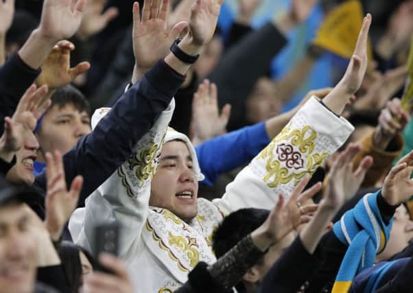 Kazakhstan fans cheer their team to Thursday's historic win over Scotland. Picture: Alexei Filippov/AP