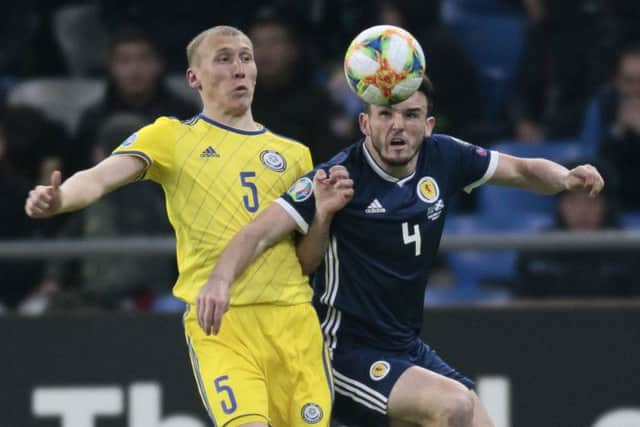 Scotland midfielder John McGinn challenges for the ball with Islambek Kuat of Kazakhstan. Picture: Alexei Filippov/AP