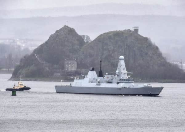 HMS Defender makes it way up the river Clyde past Dumbarton Castle.(Photo by Jeff J Mitchell/Getty Images)