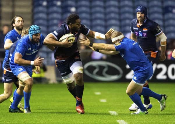 Edinburgh's Bill Mata fends off a would-be tackler on a charge upfield. Picture: Ross Parker/SNS/SRU