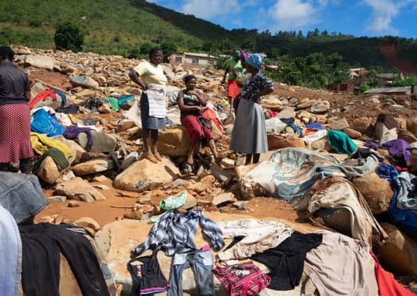 Women dry clothes recovered from rubble on March 19, 2019 in the Ngangu township of Chimanimani, after the area was hit by the Cyclone Idai. Picture: AFP/Getty Images