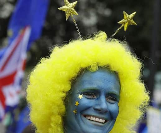A woman smiles as she participates in a Peoples Vote anti-Brexit march in London, Saturday, March 23, 2019. Pic: AP Photo/Kirsty Wigglesworth