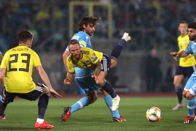 Johnny Russell challenges the San Marino defence as Marc McNulty looks on. Picture: PA.