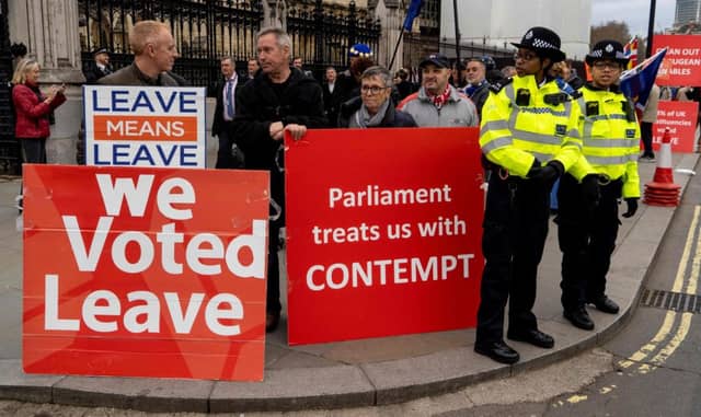 Pro-Brexit activists hold placards as they demonstrate outside the Houses of Parliament in central London. Picture: Niklas Halle'n/AFP
