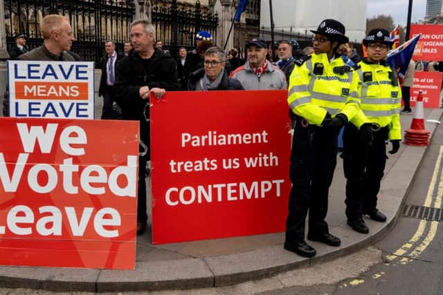 Pro-Brexit activists hold placards as they demonstrate outside the Houses of Parliament in central London. Picture: Niklas Halle'n/AFP