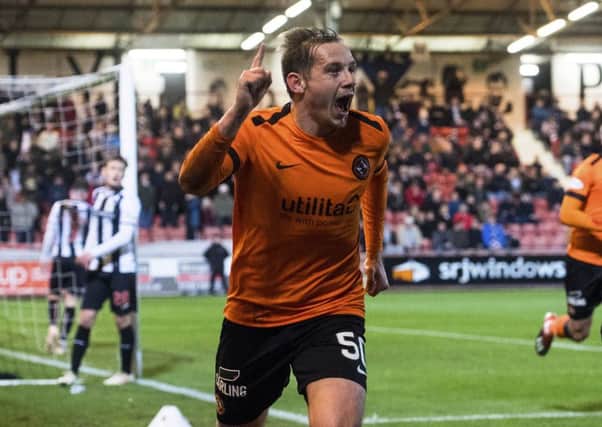 Dundee United goalscorer Peter Pawlett tangles with Dunfermline goalkeeper Ryan Scully at East End Park. Picture: SNs.