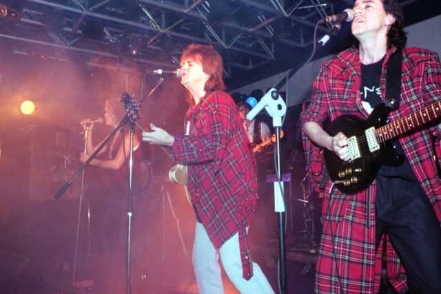Eric Faulkner and (right) Stuart Wood of the Bay City Rollers on stage at Century 2000 in Edinburgh, December 1991.