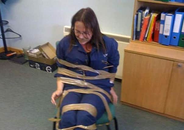 DeeAnn Fitzpatrick complained of a racist and misogynistic culture in a Scottish Government department claims she was taped to a chair and gagged by two male colleagues as a warning to keep quiet