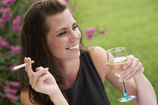 Relaxing with a glass of wine and a cigarette in an outdoor cafe