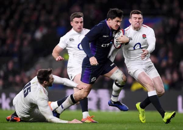 Sam Johnson evades the clutches of Elliot Daly, George Ford and Ben Spencer as he crosses to score Scotland's sixth try against England at Twickenham. Picture: Laurence Griffiths/Getty Images