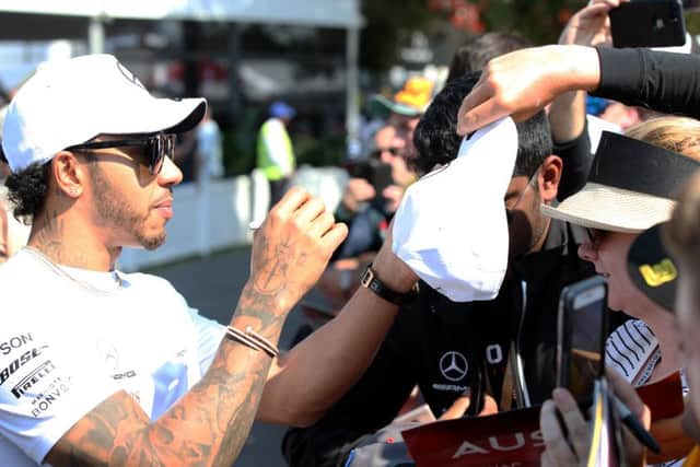 Reigning world champion Lewis Hamilton of Mercedes interacts with fans before this years Australian Grand Prix in Melbourne. Picture: Charles Coates/Getty