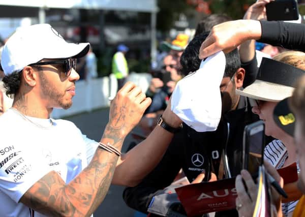 Reigning world champion Lewis Hamilton of Mercedes interacts with fans before this years Australian Grand Prix in Melbourne. Picture: Charles Coates/Getty