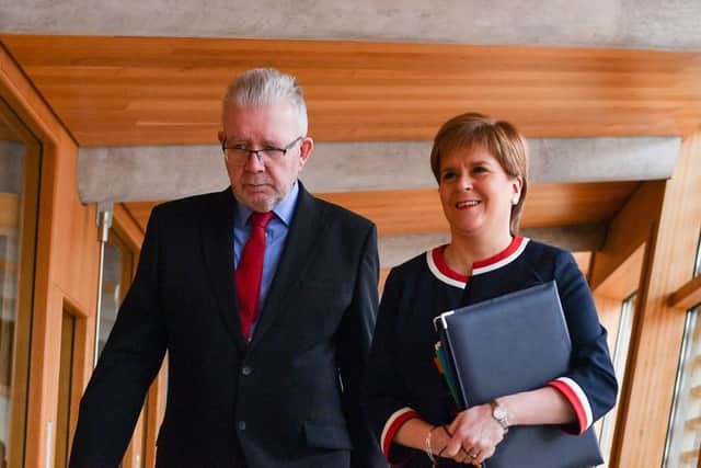 Nicola Sturgeon arrives with Brexit secretary Mike Russell for First Ministers Questions in the Scottish Parliament yesterday. Picture: Getty