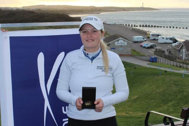 Stirling's Mirren Fraser shows off the trophy after winning the Scottish Students Women's Matchplay Championship in Lossiemouth