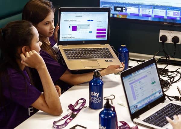 Two girls enjoy the Hackathon event at Sky's offices in Livingston.