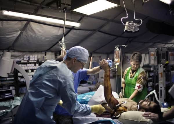 A British surgeon works to help an Afghan casualty. Picture: Getty