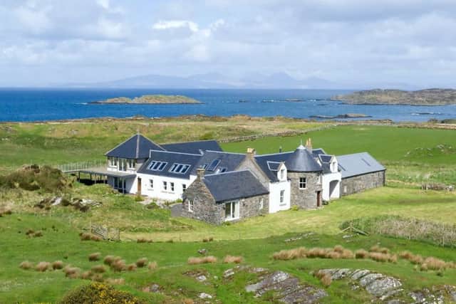 The converted farmhouse on the remote Isle of Gigha has gone on the market with views of the ocean and a library and a games room.